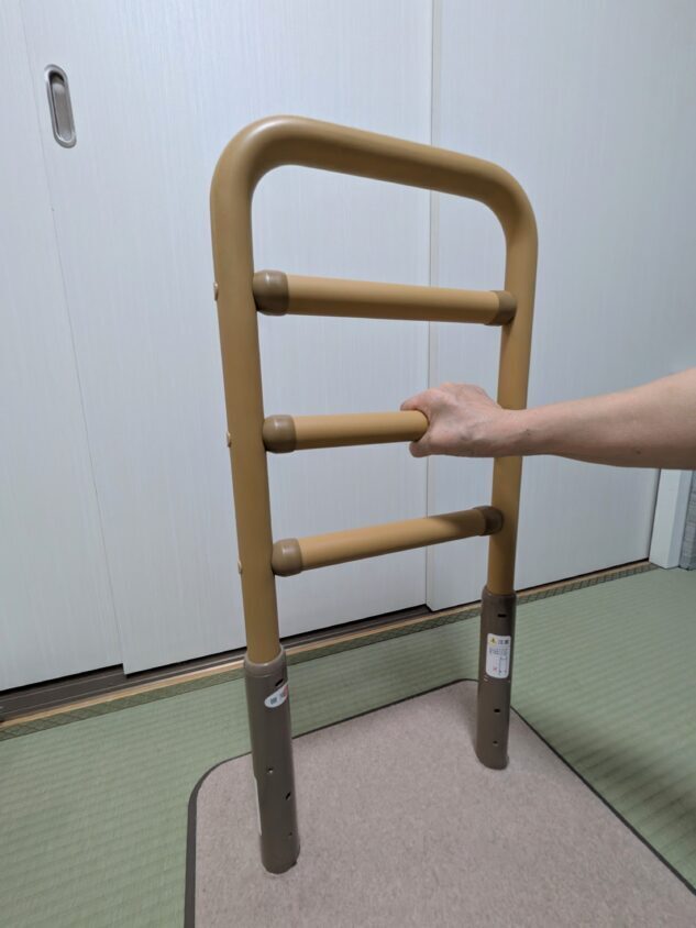 母が実際にレンタルしている置き型のはしご型手すり。布団の下に台座を敷いて設置